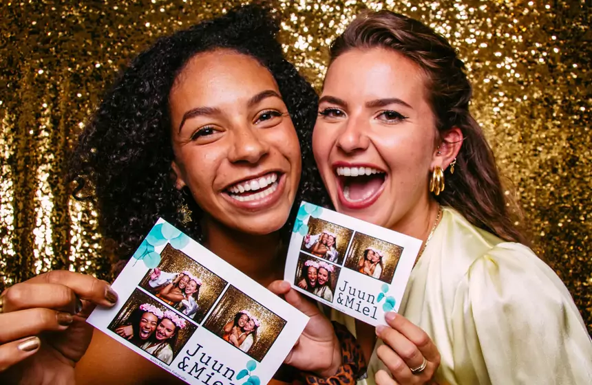 Happy guests with photobooth prints